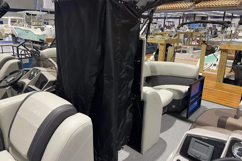 Slide: The Image of 2026 Sylvan Mirage 822 CLZ boat interior with plush seating and modern dashboard. - 13
