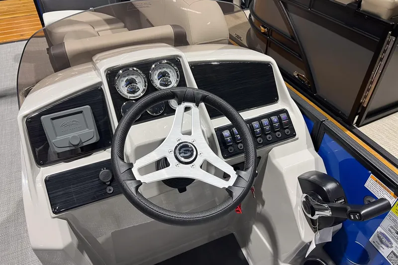 Slide: The Image of 2026 Sylvan Mirage 822 CLZ boat dashboard with steering wheel and control panel. - 15