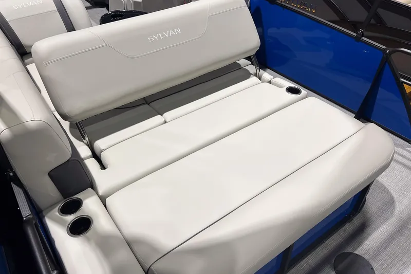 Slide: The Image of 2026 Sylvan Mirage 822 CLZ boat interior with plush seating and cup holders. - 18