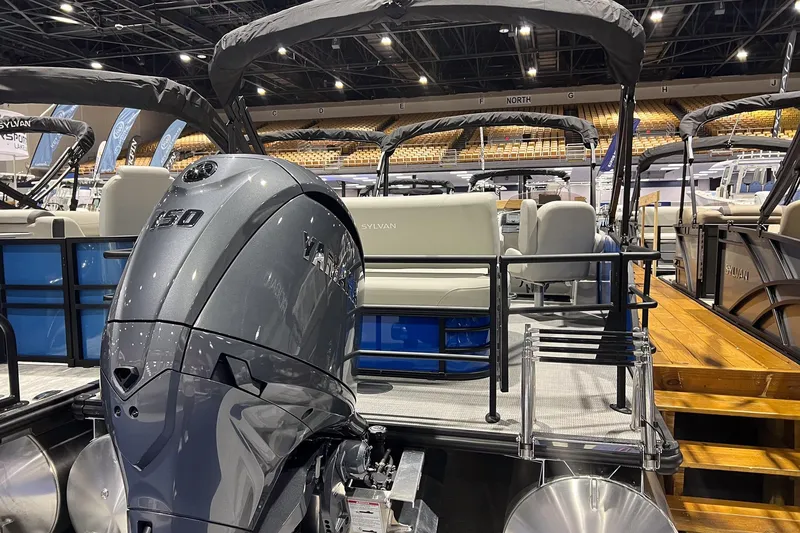Slide: The Image of 2026 Sylvan Mirage 822 CLZ pontoon boat with Yamaha outboard motor at indoor exhibition. - 2