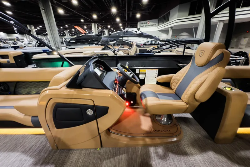 Slide: The Image of Luxurious interior of 2026 Godfrey Monaco 255 Sun Deck boat, featuring plush captain's chair and modern dashboard. - 13