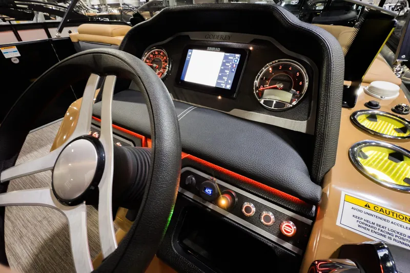 Slide: The Image of Interior dashboard of 2026 Godfrey Monaco 255 Sun Deck boat, featuring steering wheel and controls. - 16