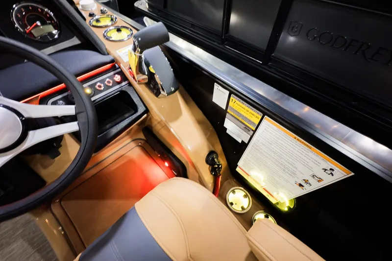 Slide: The Image of Interior view of 2026 Godfrey Monaco 255 Sun Deck boat cockpit with steering wheel and controls. - 17