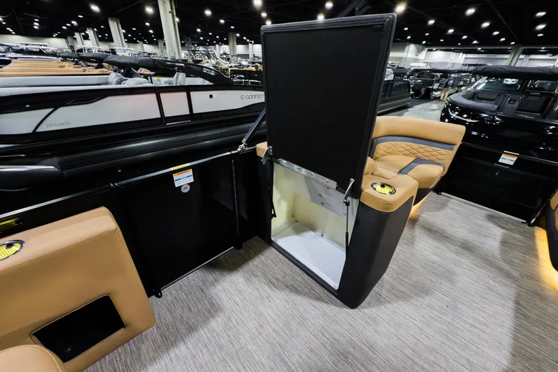 Slide: The Image of 2026 Godfrey Monaco 255 Sun Deck interior with open storage compartment and luxurious seating. - 22