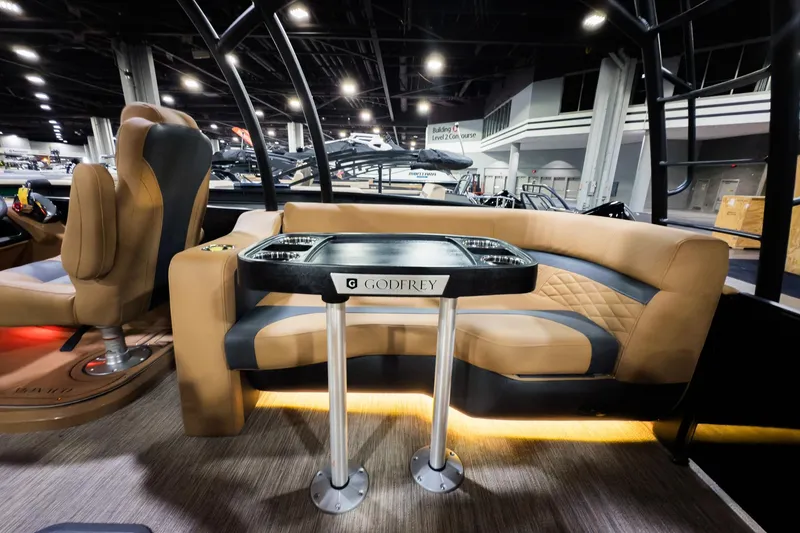 Slide: The Image of Interior of 2026 Godfrey Monaco 255 Sun Deck boat with luxurious seating and table. - 24