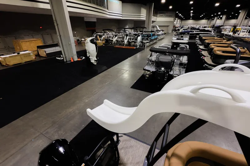 Slide: The Image of 2026 Godfrey Monaco 255 Sun Deck boats displayed at an indoor exhibition. - 30