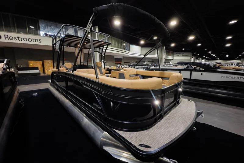 Slide: The Image of 2026 Godfrey Monaco 255 Sun Deck boat displayed indoors with luxurious seating. - 5