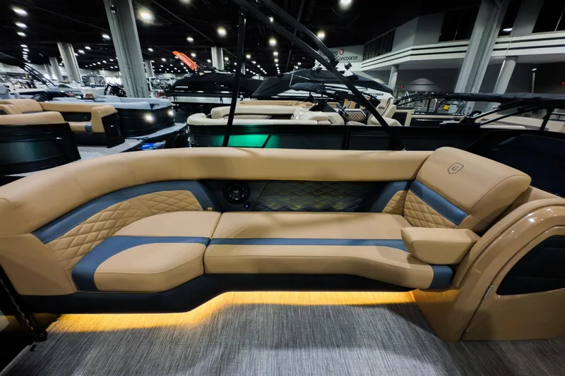 Slide: The Image of Luxurious seating on 2026 Godfrey Monaco 255 Sun Deck boat, featuring elegant tan and blue upholstery. - 8