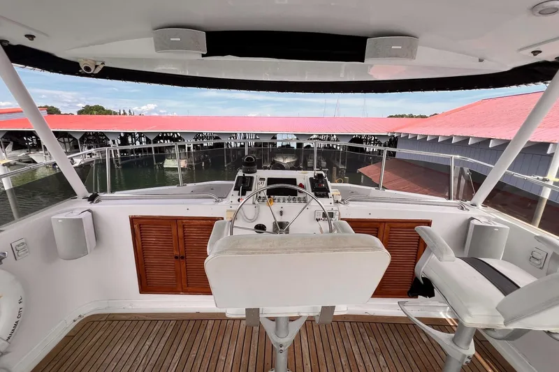 Slide: The Image of Helm of 1985 Hartman-Palmer 60 Flush Deck Motor Yacht with marina view. - 10