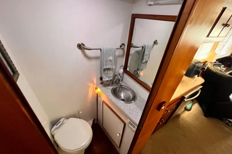 Slide: The Image of Bathroom interior of 1985 Hartman-Palmer 60 Flush Deck Motor Yacht, featuring sink and toilet. - 27