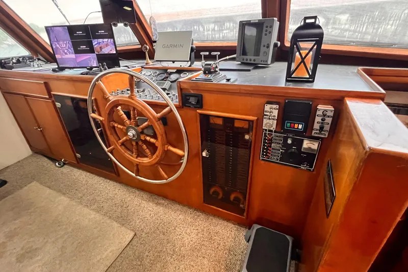 Slide: The Image of Helm of 1985 Hartman-Palmer 60 Flush Deck Motor Yacht with wooden wheel and navigation equipment. - 30