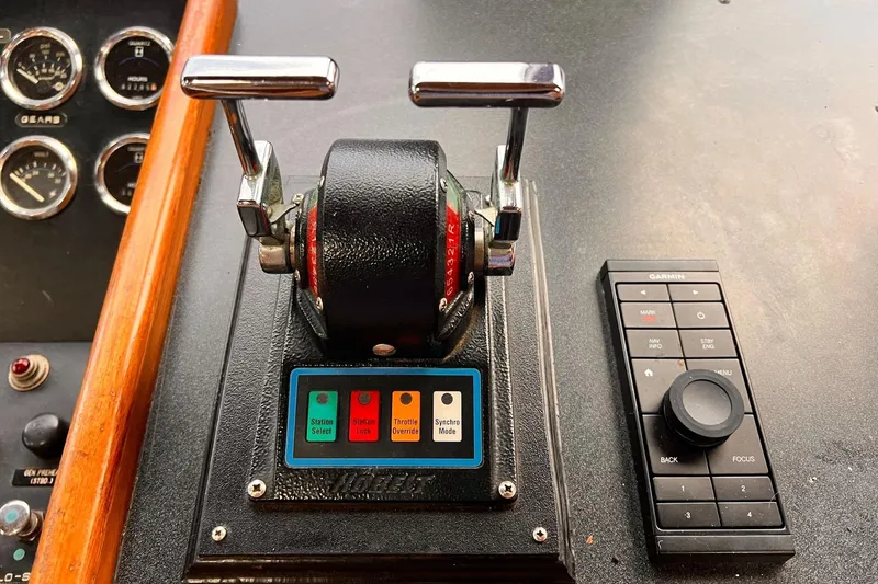 Slide: The Image of Control panel of a 1985 Hartman-Palmer 60 Flush Deck Motor Yacht with throttle and Garmin device. - 32