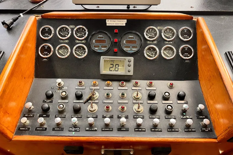 Slide: The Image of Control panel of a 1985 Hartman-Palmer 60 Flush Deck Motor Yacht with gauges and switches. - 33