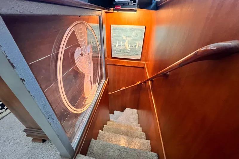 Slide: The Image of Staircase on 1985 Hartman-Palmer 60 Flush Deck Motor Yacht with wood paneling and artwork. - 34