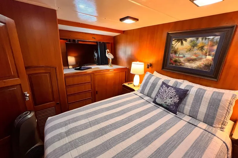 Slide: The Image of Cozy bedroom in 1985 Hartman-Palmer yacht with striped bedding and tropical artwork. - 38