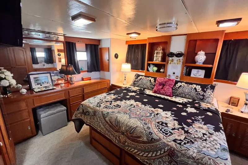 Slide: The Image of Luxurious bedroom interior of 1985 Hartman-Palmer 60 Flush Deck Motor Yacht, featuring elegant decor. - 44