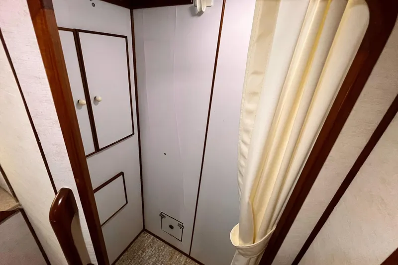 Slide: The Image of Interior of 1985 Hartman-Palmer 60 Flush Deck Motor Yacht, featuring wooden trim and storage cabinets. - 47