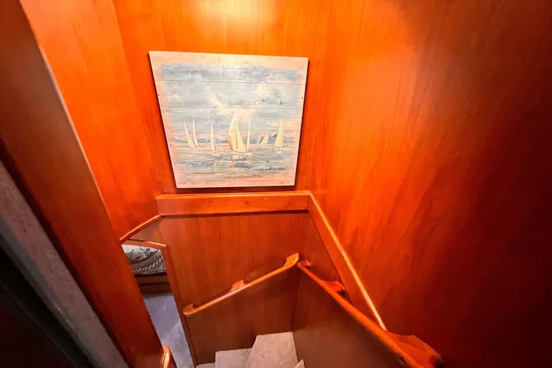 Slide: The Image of Wooden staircase with nautical artwork on Hartman-Palmer 60 Flush Deck Motor Yacht, 1985. - 48