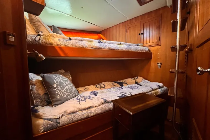 Slide: The Image of 1985 Hartman-Palmer 60 Yacht cabin with wooden interior and bunk beds. - 55