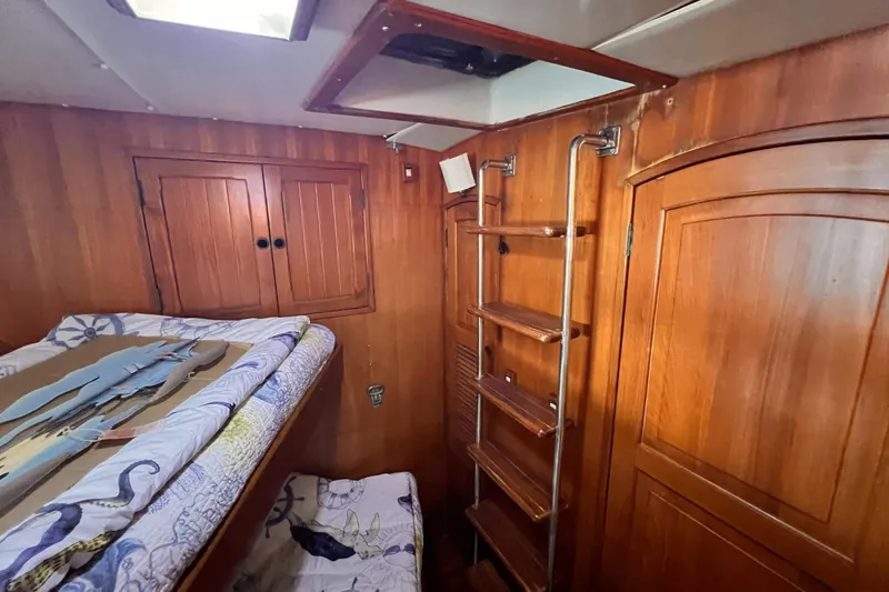 Slide: The Image of Interior of 1985 Hartman-Palmer 60 Flush Deck Motor Yacht with wooden paneling and ladder. - 56