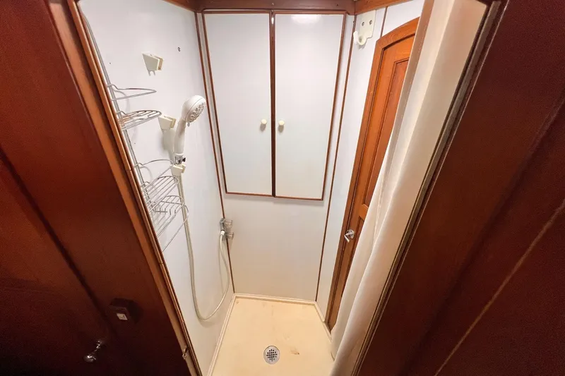 Slide: The Image of Shower area in 1985 Hartman-Palmer 60 Flush Deck Motor Yacht, featuring wooden accents. - 57