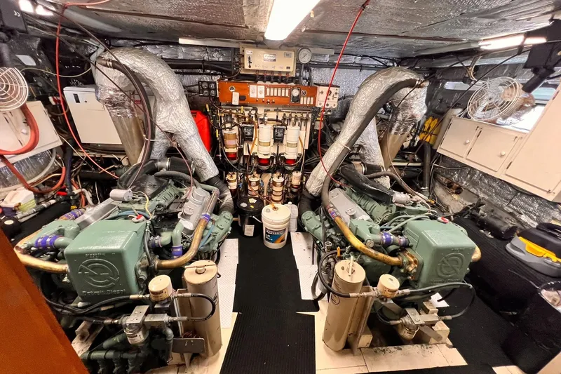 Slide: The Image of Engine room of 1985 Hartman-Palmer 60 Flush Deck Motor Yacht, showcasing dual engines. - 58