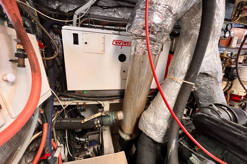 Slide: The Image of Engine room of 1985 Hartman-Palmer 60 Flush Deck Motor Yacht with generator and pipes. - 61