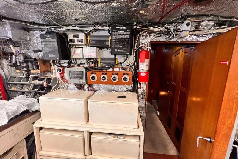 Slide: The Image of Engine room of 1985 Hartman-Palmer 60 Flush Deck Motor Yacht with control panels and equipment. - 62