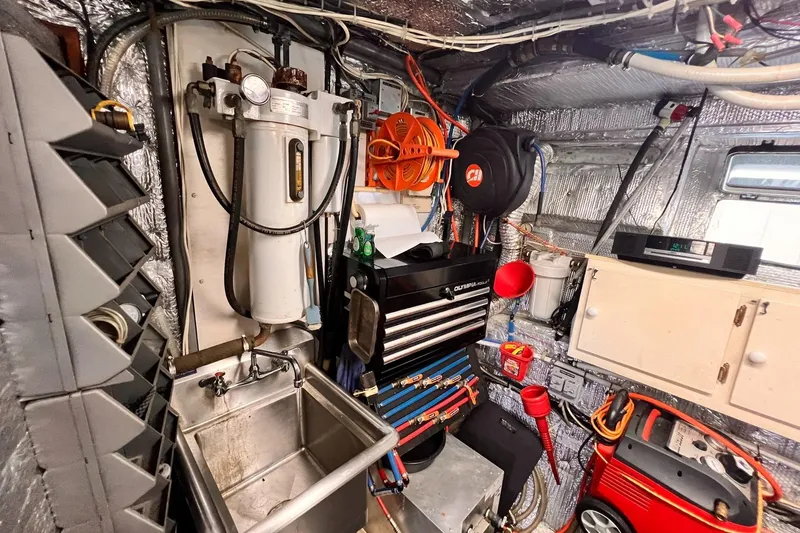 Slide: The Image of Engine room of 1985 Hartman-Palmer 60 Flush Deck Motor Yacht with tools and equipment. - 63