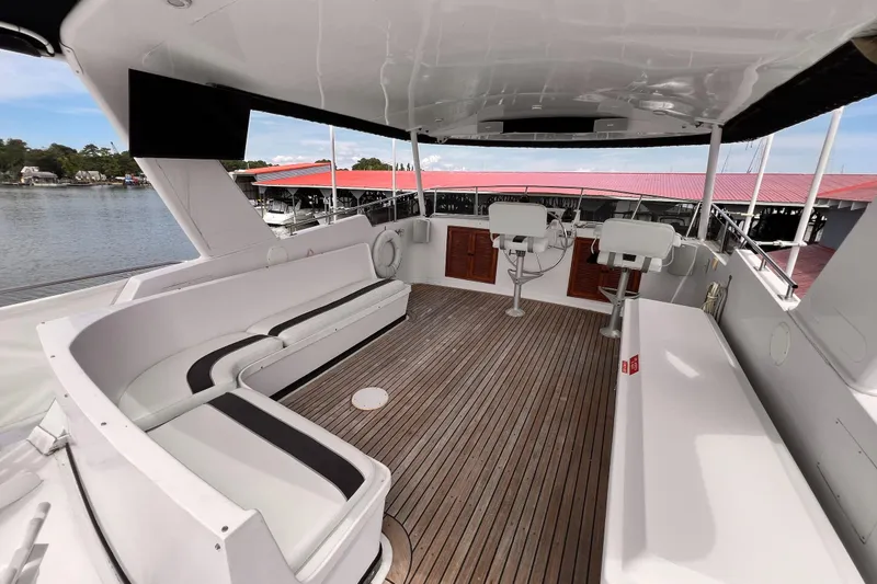 Slide: The Image of Spacious deck of 1985 Hartman-Palmer 60 Flush Deck Motor Yacht with seating and helm. - 9