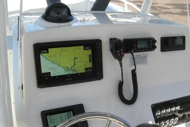 Slide: The Image of 2024 Edgewater 208CC boat dashboard with navigation and communication equipment. - 11