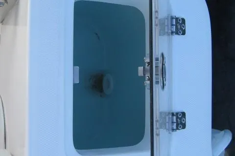 Slide: The Image of 2024 Edgewater 208CC boat livewell with open lid and secure latch. - 3