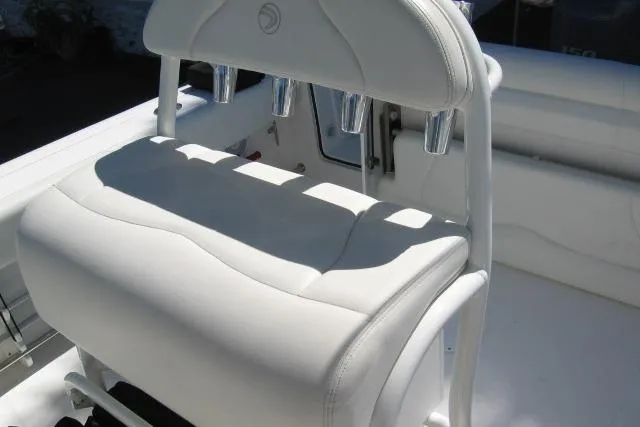 Slide: The Image of White seating on 2024 Edgewater 208CC boat, featuring rod holders and sleek design. - 5