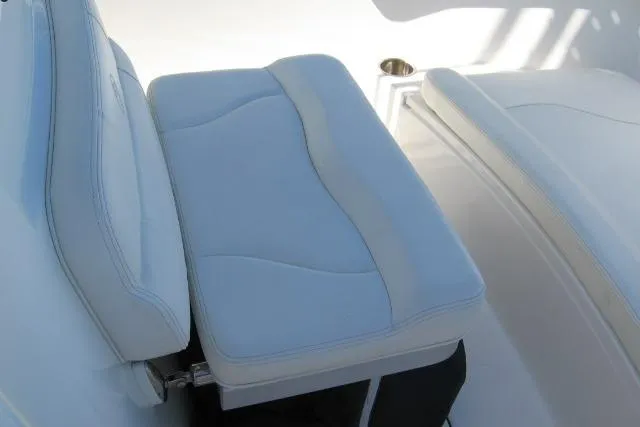 Slide: The Image of 2024 Edgewater 208CC boat interior with cushioned seating and cup holder. - 7