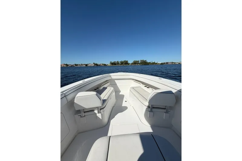 Slide: The Image of 2018 Jupiter 38 FS boat interior with seating, on calm water under clear blue sky. - 11