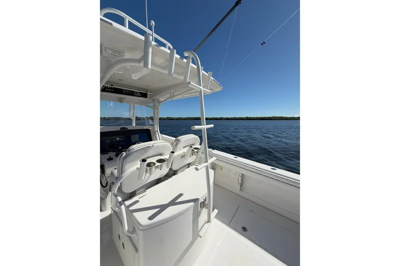 Slide: The Image of 2018 Jupiter 38 FS boat interior with helm seats, ocean view, and clear blue sky. - 13