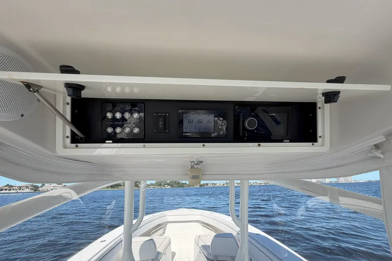 Slide: The Image of 2018 Jupiter 38 FS boat dashboard with control panel and navigation system on open water. - 15