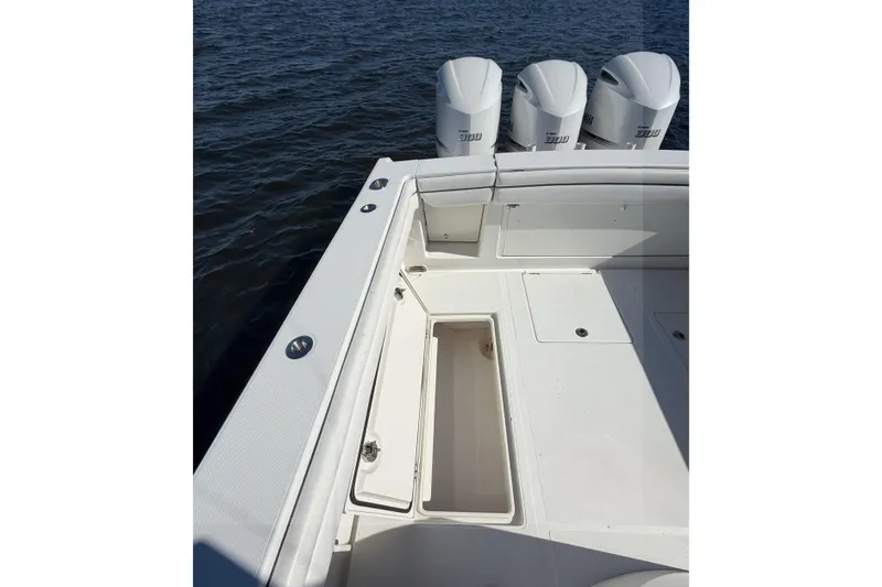 Slide: The Image of 2018 Jupiter 38 FS boat deck with storage and triple engines on water. - 19