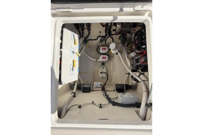 Slide: The Image of 2018 Jupiter 38 FS boat compartment with wiring and plumbing systems. - 23