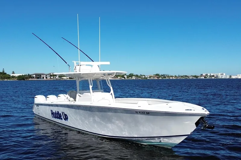 Slide: The Image of 2018 Jupiter 38 FS boat on calm water under clear blue sky. - 4