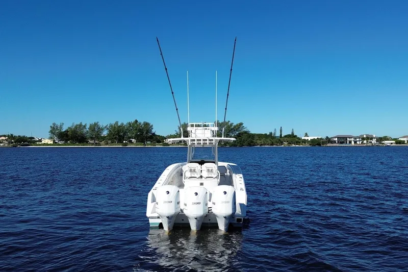 Slide: The Image of 2018 Jupiter 38 FS boat with triple engines on a calm blue lake. - 7