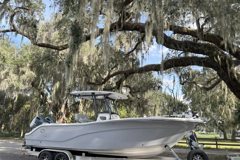 The Image of 2023 Sea Fox 268 Commander boat on trailer under mossy trees. - 1