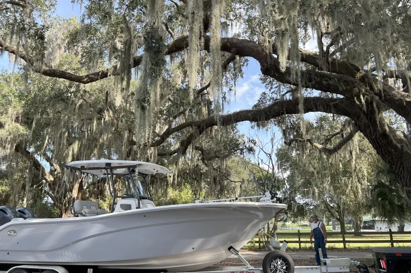Slide: The Image of 2023 Sea Fox 268 Commander boat under large oak tree with Spanish moss. - 2