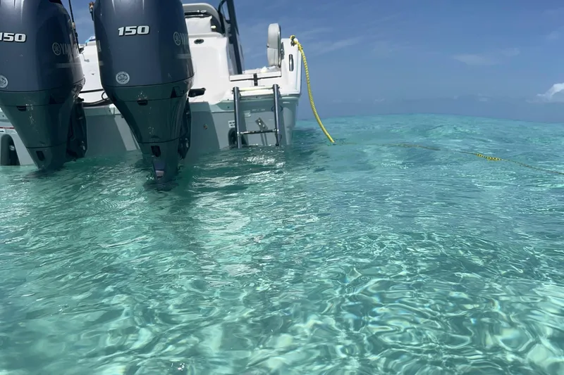 Slide: The Image of Sea Fox 268 Commander 2023 in clear turquoise water, featuring dual Yamaha 150 engines. - 4