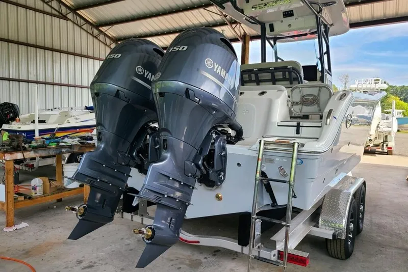 Slide: The Image of 2023 Sea Fox 268 Commander with dual Yamaha 150 engines in a boat shed. - 7