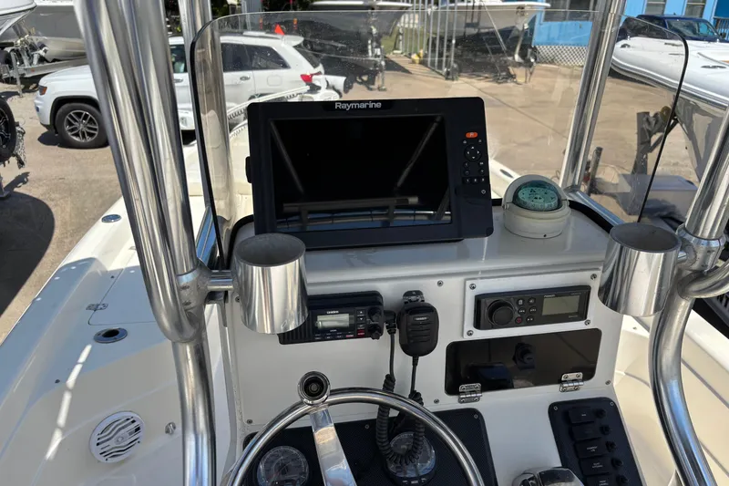 Slide: The Image of Center console of a 2006 Shearwater Boatworks 2400Z with navigation equipment and controls. - 14
