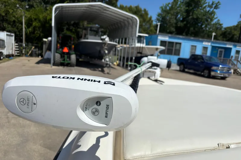 Slide: The Image of Minn Kota Riptide motor on 2006 Shearwater Boatworks 2400Z, parked near blue building. - 8