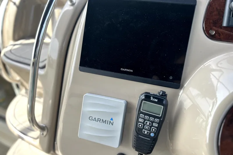 Slide: The Image of 2004 Wellcraft 47 Excalibur dashboard with Garmin and Icom devices. - 19
