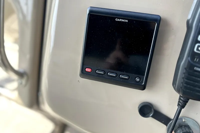 Slide: The Image of Garmin device on 2004 Wellcraft 47 Excalibur boat dashboard, featuring control buttons. - 20