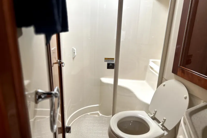 Slide: The Image of Bathroom interior of 2004 Wellcraft 47 Excalibur yacht, featuring shower and toilet. - 28